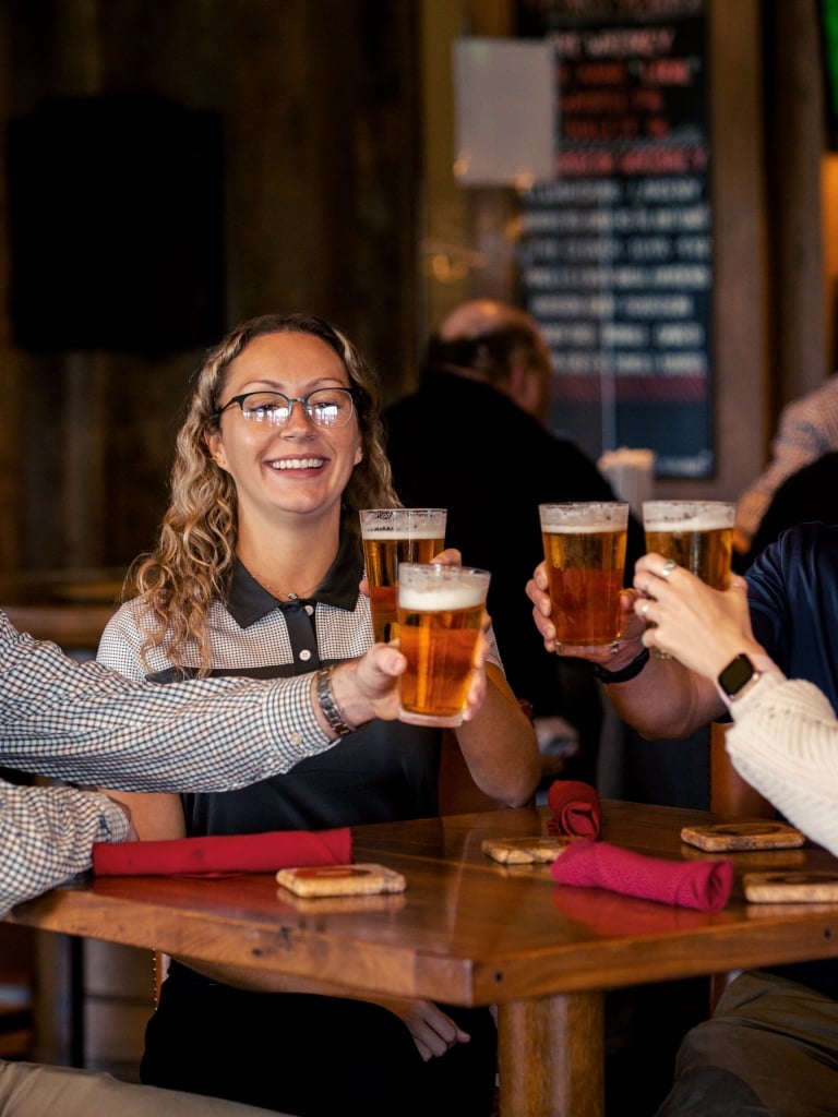 People cheer-sing with beer at Fraser's Restaurant